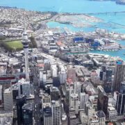 Aerial view of Auckland CBD, harbour, and Sky Tower, representing a major New Zealand business hub for social media marketing and management