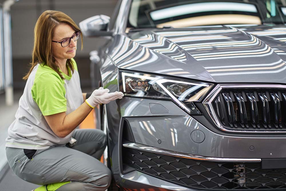 Skoda Auto staff examining the vehicle